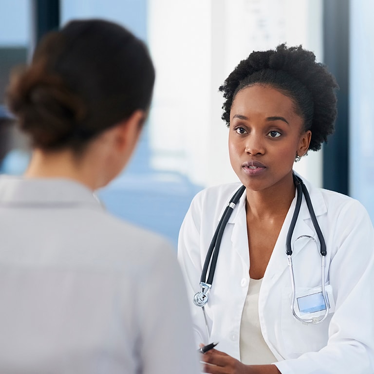 Healthcare professional speaking with patient